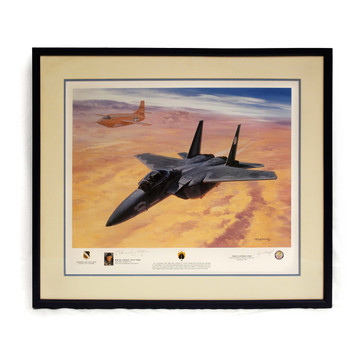 Lithograph of a McDonnell Douglas F-15D jet flying high above a desert landscape