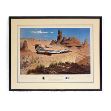 Framed and matted lithograph of two f-104 starfighter jets flying against a background of southwest American desert scenery