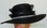 Ladies black hat with wide wavy brim with jewelry band