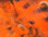Hareline Black Barred Rabbit Strips- 1/8" (Hot Orange)