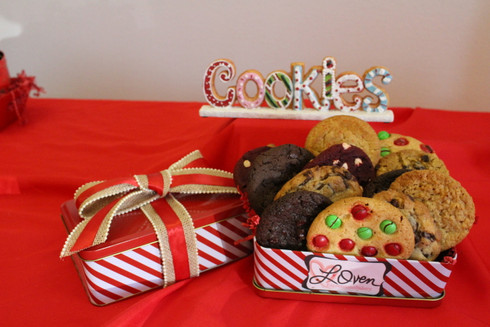 One dozen gourmet cookies in Christmas tin.  Enjoy delicious and individually wrapped gourmet cookies including chocolate chip, oatmeal raisin, double chocolate, red velvet, rainbow, and snicker doodle cookies.