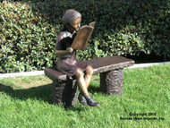 Girl Reading a Book on a Bench