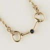 A 14k gold bit with buckles necklace with a 3.5mm center sapphire of .19 carat. 16" in length. Another classic piece!