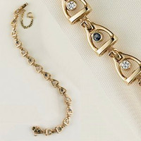 A 14k gold linked small stirrup and buckle bracelet with Sapphires and Diamonds