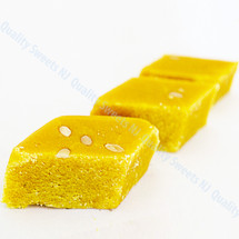 Besan burfi squares garnished with sliced almonds