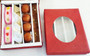 Red gift box with clear window showing assorted sweets