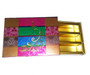 Side view of peacock gift box showing compartments of sweets