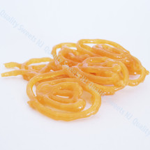 Orange jalebi spirals soaked in saffron syrup