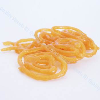 Orange jalebi spirals soaked in saffron syrup