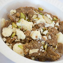 Moong dal halwa made with ghee and topped with slivered almonds