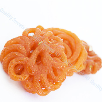 Flower shaped golden imarti soaked in syrup