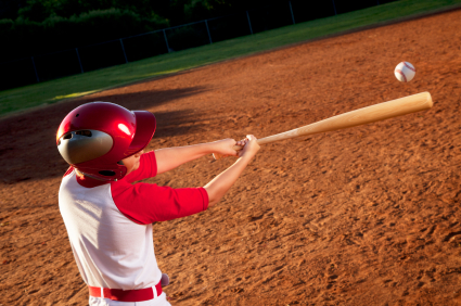 youth hitting with a wood bat