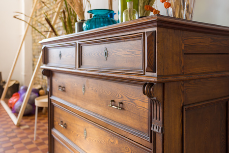 mahogany wood chest with various vases on top