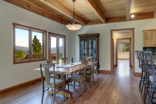 a dining room with an antique dining table and chair set near a china cabinet