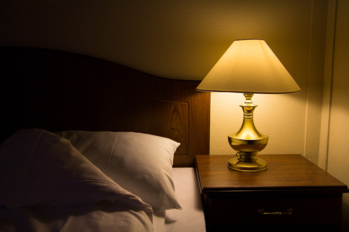 nightstand with a lamp
