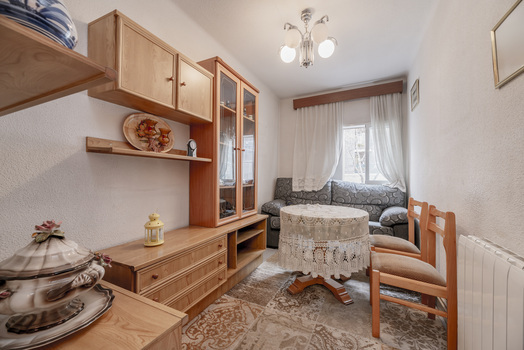 a small apartment with wooden chairs and antique cabinets