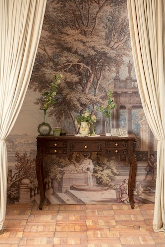Victorian console table behind pulled curtains