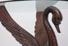 Wooden swan wings and neck hold up the glass tabletop