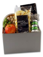 Welcome themed gift basket arrangement filled with fruit, chocolates, sweet and salty snacks, and drink