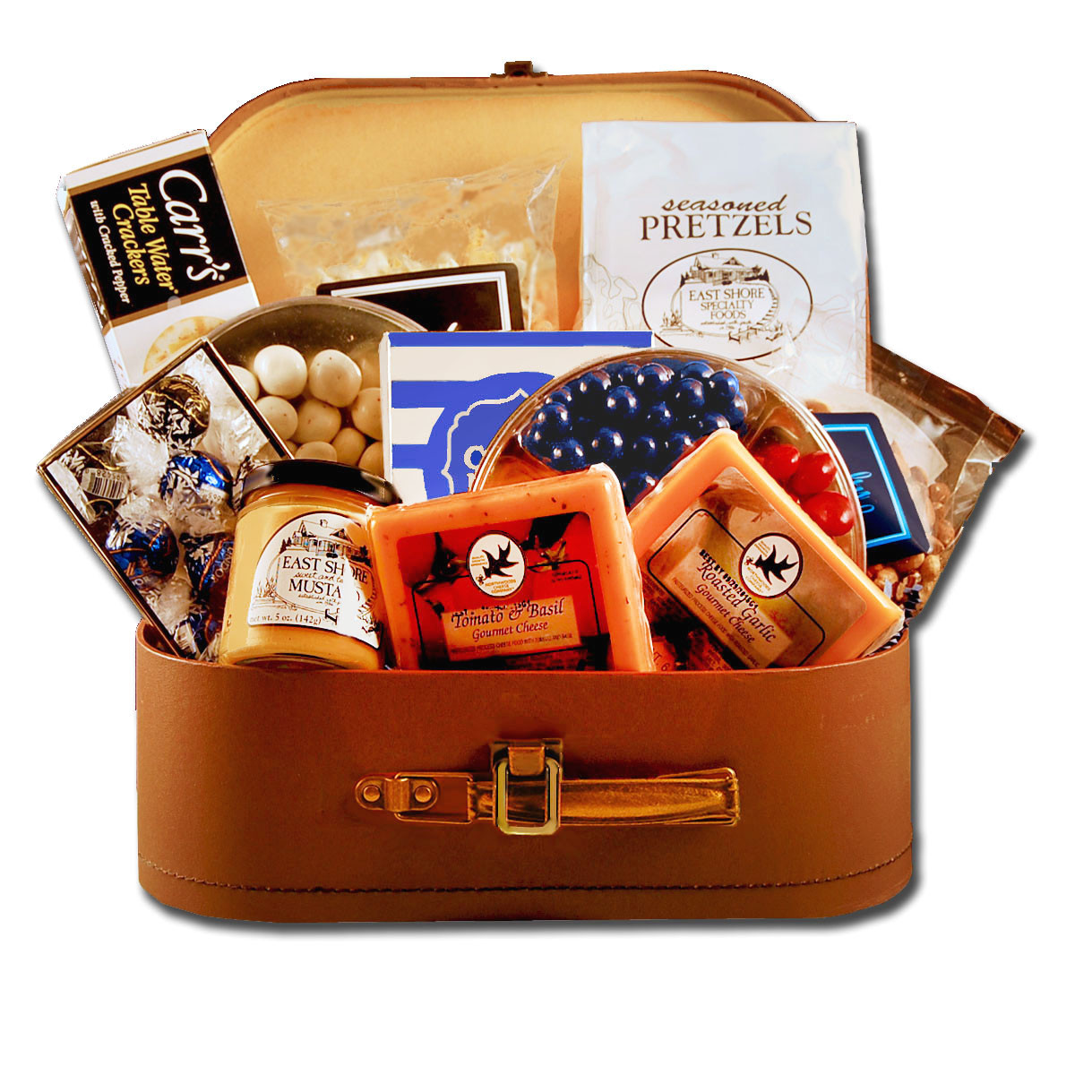 Travel themed gift basket arrangement with chocolates, sweet and salty snacks, dried fruit, caramels, and cookies