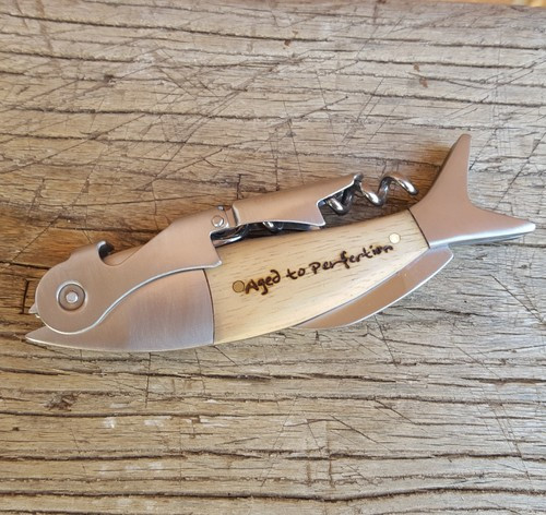 Hand-crafted fish shaped corkscrew made of white oak wood and steel hardware with choice of word on one side
