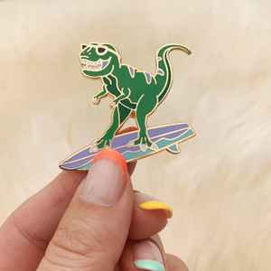 AC00149-GLD-OS Surfing Dinosaur Enamel Pin - T-Rex Enamel Lapel Pin -Surfing Enamel Pin - Cute Dinosaur Pin - Surfing Gifts for Women - Surfer - Wildflower + Co - VSCO