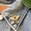 Tiny Bee Enamel Pin - Gold - VSCO Pins - Wildflower + Co.
………………………………….………………………………….
Bee yourself with this adorable, teeny bee pin. Subtle symbols are layered within the bee - wings have lightning bolts & body features a crescent moon. Teeny tiny, just like if a queen bee were to land on you! Perfect size for a collar or anywhere you want a little accent. Hard enamel pin.