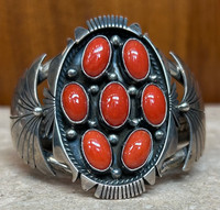 BRACELETS 7 CORAL OVAL CABOCHONS SET IN AN OVAL SHAPED STERLING SILVER CUFF SETTING