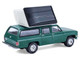 1990 Chevrolet Suburban Green with Modern Rooftop Camper The Great Outdoors Series 4 1/64 Diecast Model Car Greenlight 38080E