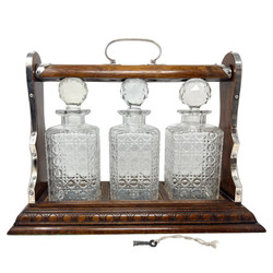 Antique English Golden Oak and Cut Crystal 3-Bottle Tantalus with Sheffield Silver Plated Mounts along with Lock and Working Key, Circa 1890.