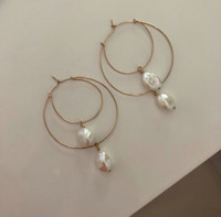 A modern take on the romance of pearls. Light weight hoop earrings handmade with 14kt gold filled elements and real pearls. 45mm in diameter, approximately 55mm long.