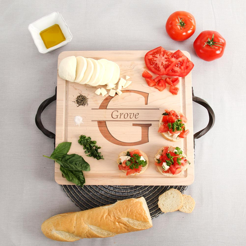 https://cdn10.bigcommerce.com/s-5avdh/products/526/images/2176/square-maple-cutting-board-cast-iron-handles-personalized-family-name__59971.1503582260.1280.1280.jpg?c=2