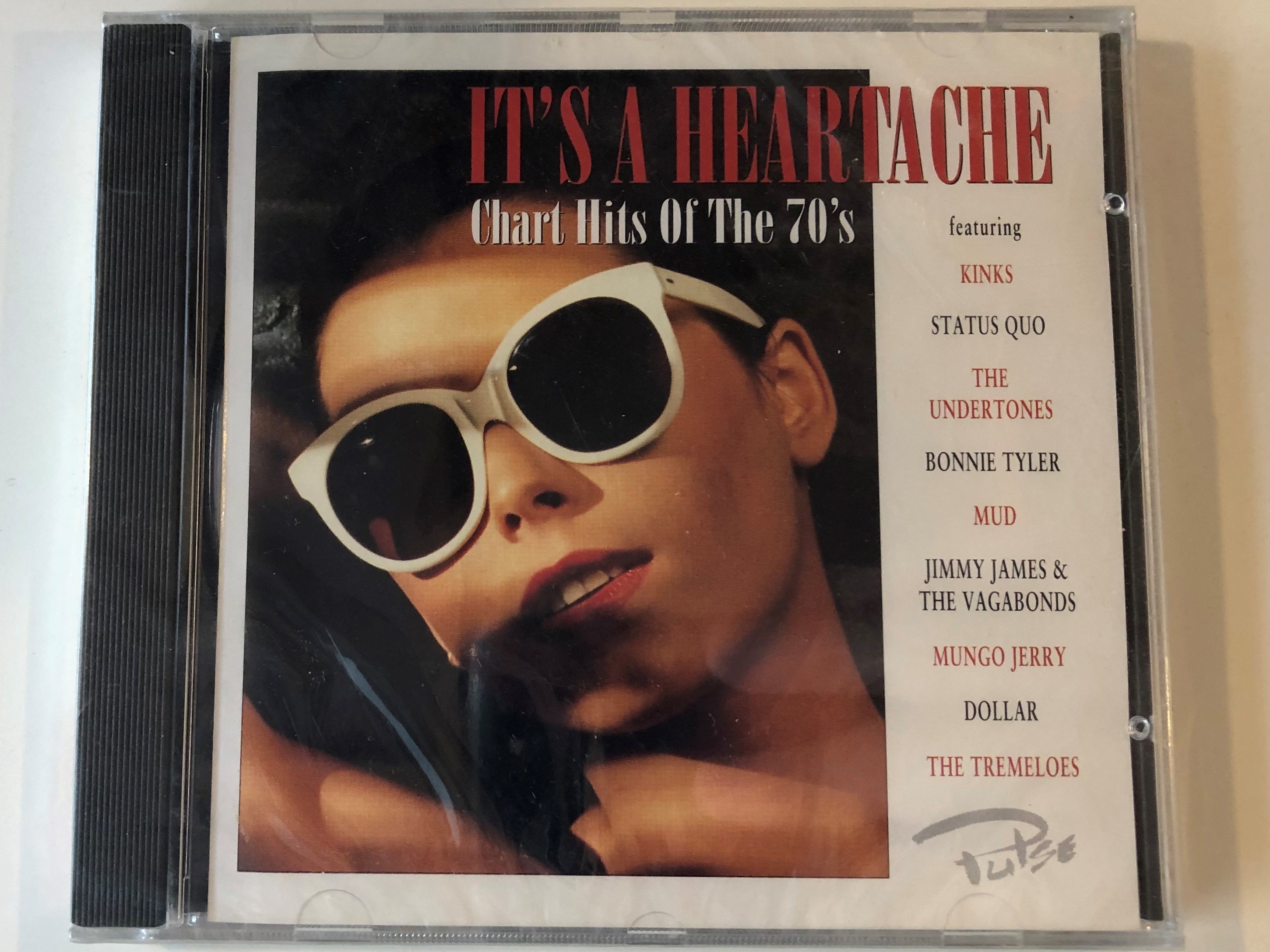 it-s-a-heartache-chart-hits-of-the-70-s-featuring-kinks-status-quo-the-under-tones-bonnie-tyler-mud-jimmy-james-the-vagabonds-mungo-jerry-dollar-the-tremeloes-pulse-audio-cd-1996-1-.jpg