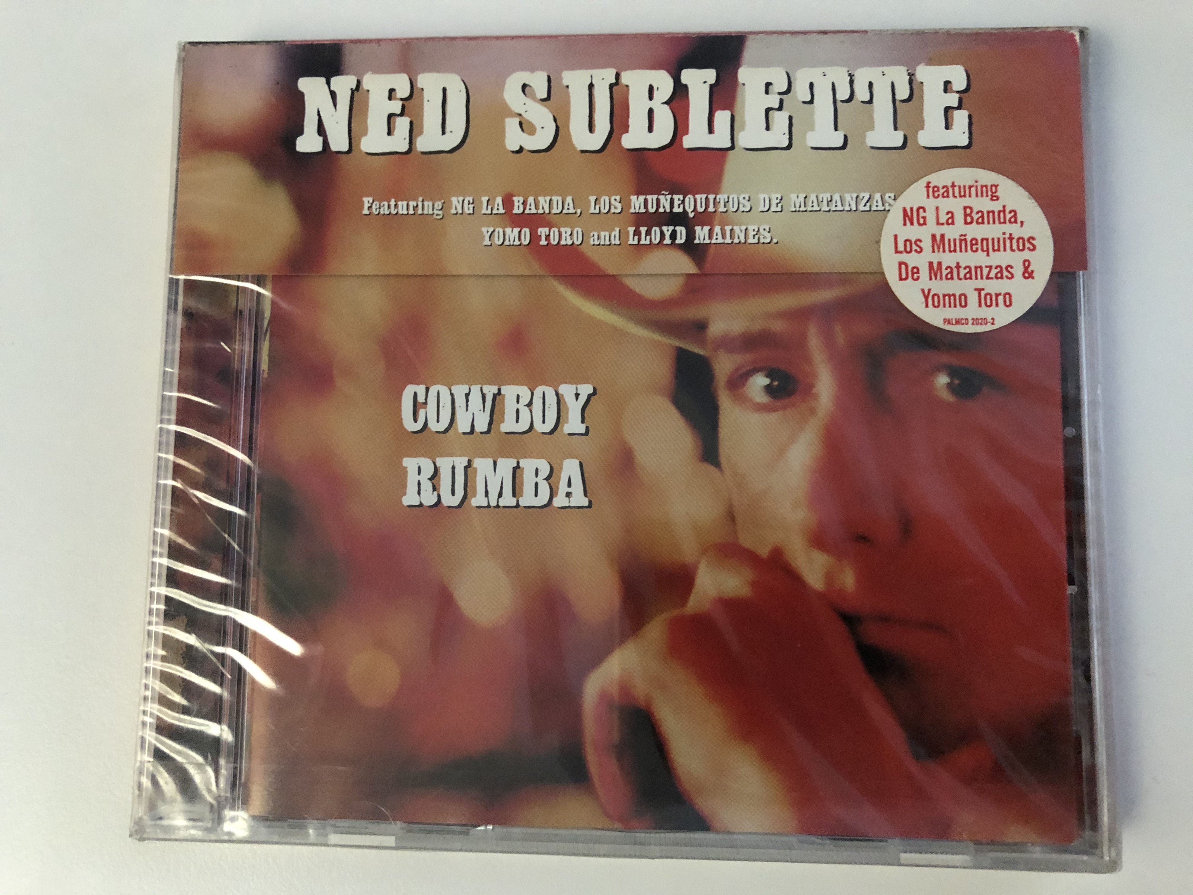 ned-sublette-cowboy-rumba-featuring-ng-la-banda-los-mu-equitos-de-matanzas-yomo-toro-and-lloyd-maines-palm-pictures-audio-cd-1999-palmcd-2020-2-1-.jpg