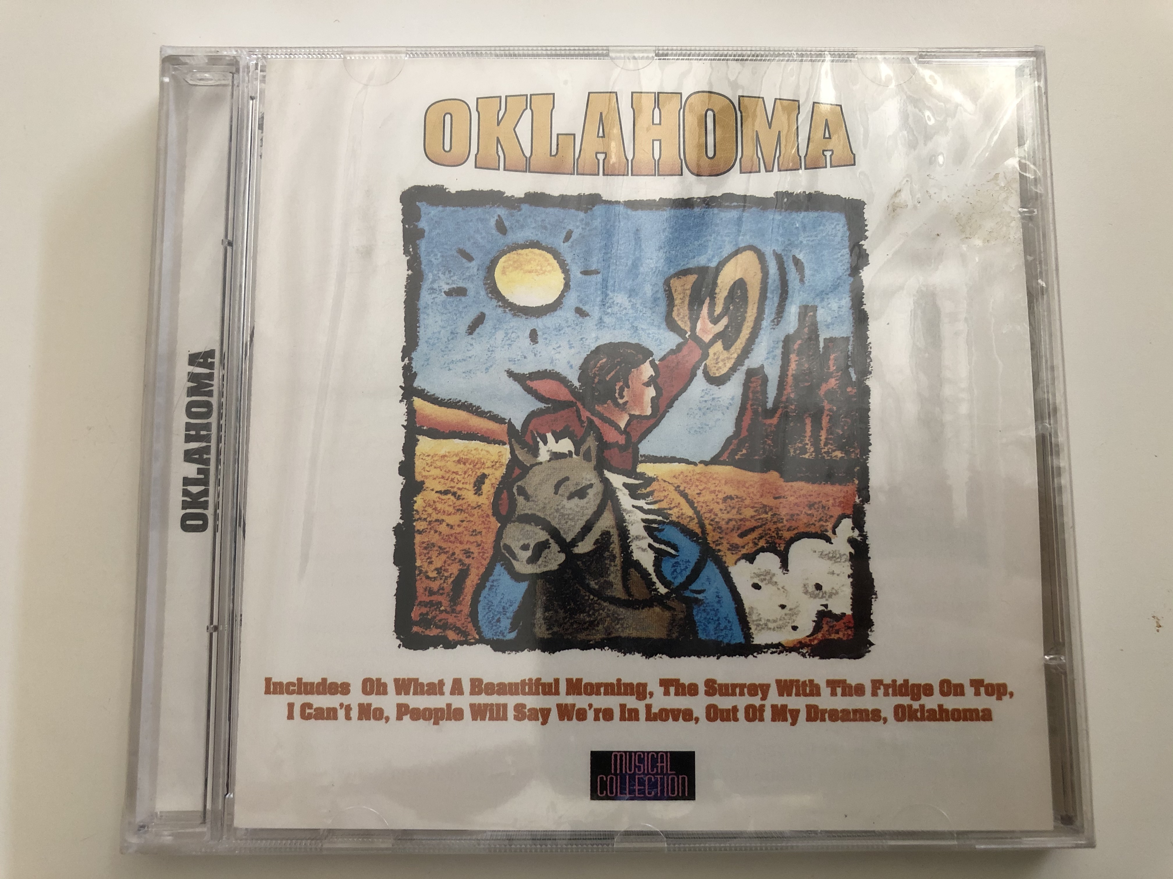 oklahoma-includes-oh-what-a-beautiful-morning-the-surrey-with-the-fridge-on-top-i-can-t-no-people-will-say-we-re-in-love-out-of-my-dreams-oklahoma-musical-collection-audio-cd-8811-2-1-.jpg