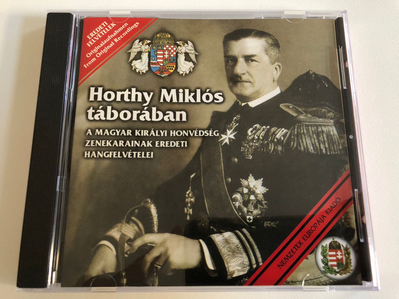 https://cdn10.bigcommerce.com/s-62bdpkt7pb/products/0/images/186457/Horthy_Mikls_Tborban_A_Magyar_Kiralyi_Honvedseg_Zenekarainak_Eredeti_Hangfelvetelei_Nemzetek_Eurpja_Kiad_Audio_CD_2001_NECD_002_1__67864.1628269162.1280.1280.JPG?c=2&_gl=1*8v75r7*_ga*MjA2NTIxMjE2MC4xNTkwNTEyNTMy*_ga_WS2VZYPC6G*MTYyODI2Mjk5MS4yMS4xLjE2MjgyNjkyOTIuNjA.