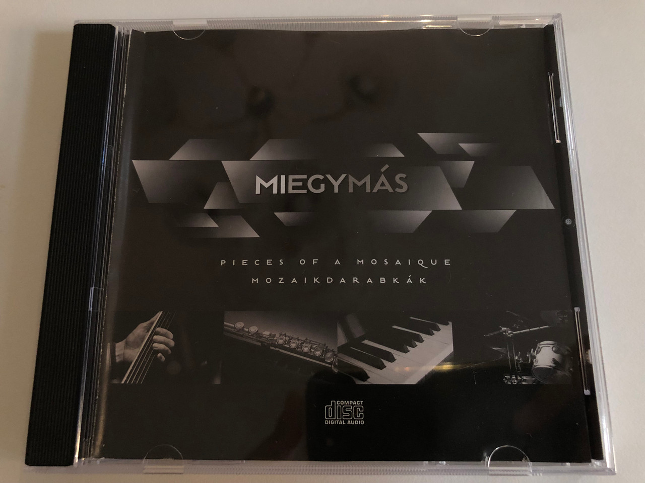 https://cdn10.bigcommerce.com/s-62bdpkt7pb/products/0/images/186897/Miegyms_Pieces_Of_A_Mosaique_Mozaikdarabkk_NarRator_Records_Audio_CD_2011_NRR119_1__04459.1628592773.1280.1280.JPG?c=2&_gl=1*a7u8s8*_ga*MjA2NTIxMjE2MC4xNTkwNTEyNTMy*_ga_WS2VZYPC6G*MTYyODU4ODcyOC4yNi4xLjE2Mjg1OTI2MTYuNDI.