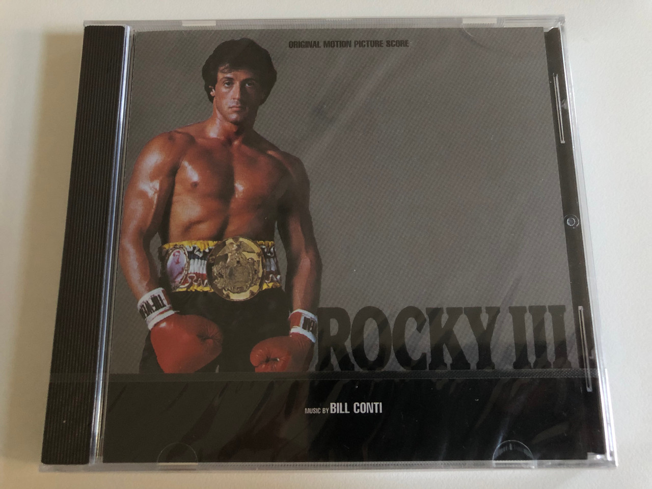 https://cdn10.bigcommerce.com/s-62bdpkt7pb/products/0/images/187282/Rocky_III_Original_Motion_Picture_Score_-_Music_by_Bill_Conti_EMI_Electrola_Audio_CD_CDP_538-7_46561_2_1__10196.1628760948.1280.1280.JPG?c=2&_gl=1*1ot81wh*_ga*MjA2NTIxMjE2MC4xNTkwNTEyNTMy*_ga_WS2VZYPC6G*MTYyODc1NDIxMC4zMC4xLjE2Mjg3NjExMDguNjA.
