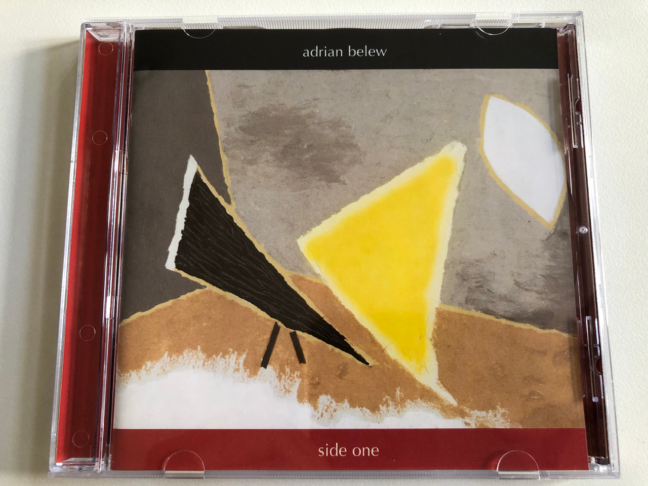 https://cdn10.bigcommerce.com/s-62bdpkt7pb/products/0/images/189067/Adrian_Belew_Side_One_Sanctuary_Records_Audio_CD_2004_SANCD351_1__22008.1629898552.1280.1280.JPG?c=2&_gl=1*k1ijqp*_ga*MjA2NTIxMjE2MC4xNTkwNTEyNTMy*_ga_WS2VZYPC6G*MTYyOTg5NTI3OS40NS4xLjE2Mjk4OTc5NzUuNTc.