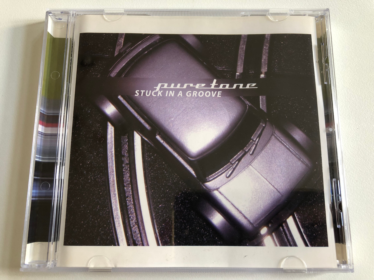https://cdn10.bigcommerce.com/s-62bdpkt7pb/products/0/images/189074/Puretone_Stuck_In_A_Groove_Illustrious_Audio_CD_2003_ILLLP003_1__46736.1629954336.1280.1280.JPG?c=2&_gl=1*nn3ymi*_ga*MjA2NTIxMjE2MC4xNTkwNTEyNTMy*_ga_WS2VZYPC6G*MTYyOTk1NDA0My40Ni4wLjE2Mjk5NTQwNDMuNjA.