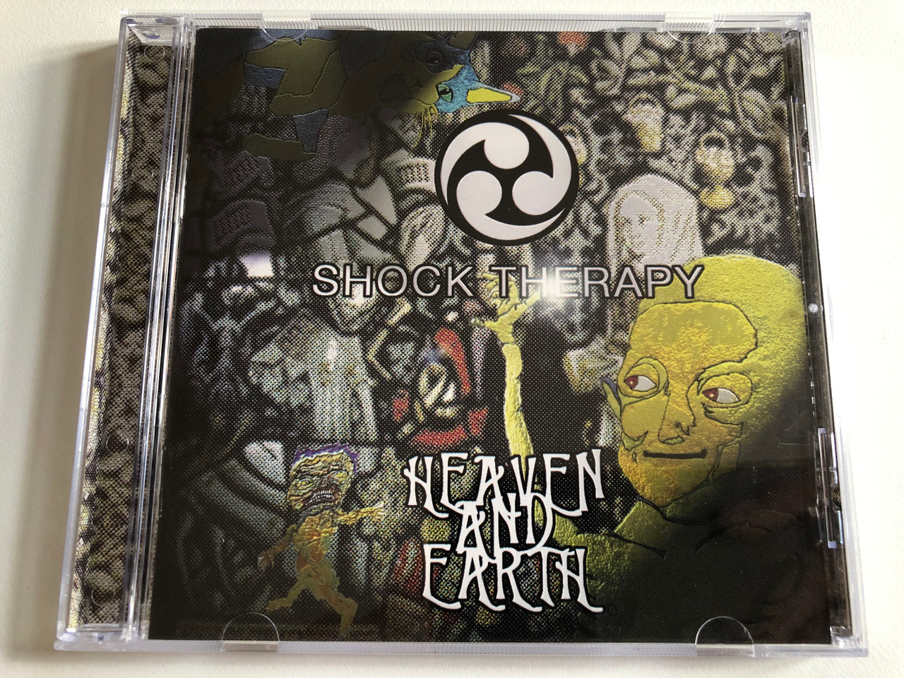 https://cdn10.bigcommerce.com/s-62bdpkt7pb/products/0/images/189159/Shock_Therapy_Heaven_And_Earth_Psycho_Clown_Audio_CD_CD_004_1__84854.1629961451.1280.1280.JPG?c=2&_gl=1*1u1olmk*_ga*MjA2NTIxMjE2MC4xNTkwNTEyNTMy*_ga_WS2VZYPC6G*MTYyOTk1NDA0My40Ni4xLjE2Mjk5NjE0NDcuNjA.