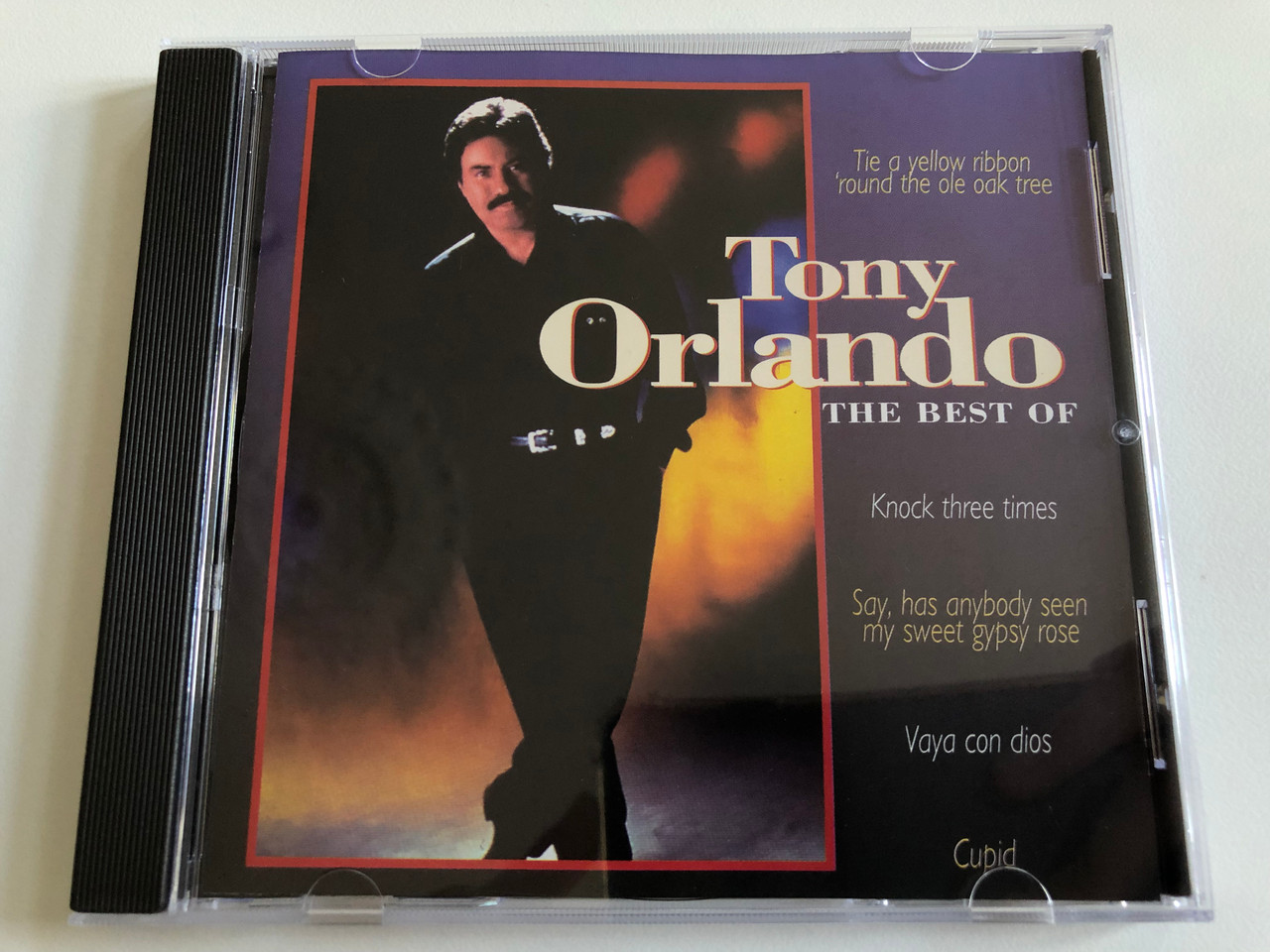 https://cdn10.bigcommerce.com/s-62bdpkt7pb/products/0/images/189320/Tony_Orlando_The_Best_Of_Tie_A_Yellow_Ribbon_Round_The_Old_Oak_Tree_Knock_Three_Times_Say_Has_Anybody_Seen_My_Sweet_Gypsy_Rose_Vaya_Con_Dios_Wise_Buy_Audio_CD_1996_WB_866692_1__63408.1630043909.1280.1280.JPG?c=2&_gl=1*de6iu*_ga*MjA2NTIxMjE2MC4xNTkwNTEyNTMy*_ga_WS2VZYPC6G*MTYzMDA0MDQ4Mi40OC4xLjE2MzAwNDM3NzkuMTM.