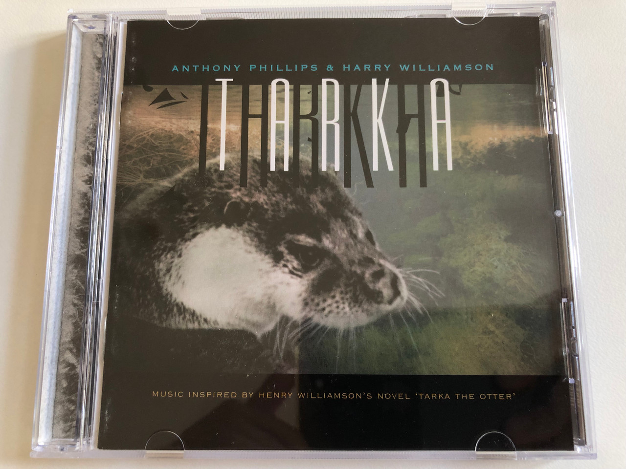 https://cdn10.bigcommerce.com/s-62bdpkt7pb/products/0/images/189337/Anthony_Phillips_Harry_Williamson_Tarka_Music_Inspired_By_Henry_Williamsons_Novel_Tarka_The_Otter_Blueprint_Audio_CD_1996_BP219CD_1__89931.1630045000.1280.1280.JPG?c=2&_gl=1*4flanb*_ga*MjA2NTIxMjE2MC4xNTkwNTEyNTMy*_ga_WS2VZYPC6G*MTYzMDA0MDQ4Mi40OC4xLjE2MzAwNDQ4NjMuNDE.