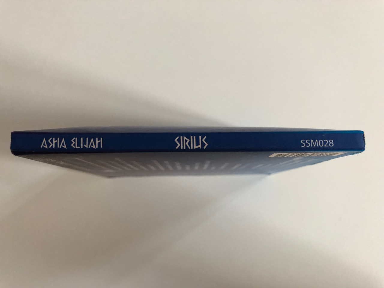 https://cdn10.bigcommerce.com/s-62bdpkt7pb/products/0/images/191285/Sirilis_-_Asha_Elijah_Singing_Stone_Music_2x_Audio_CD_SSM028_6__92234.1631596166.1280.1280.JPG?c=2&_gl=1*1iy8hv0*_ga*MjA2NTIxMjE2MC4xNTkwNTEyNTMy*_ga_WS2VZYPC6G*MTYzMTU5NDA4MS43OS4xLjE2MzE1OTU5NzcuMjA.