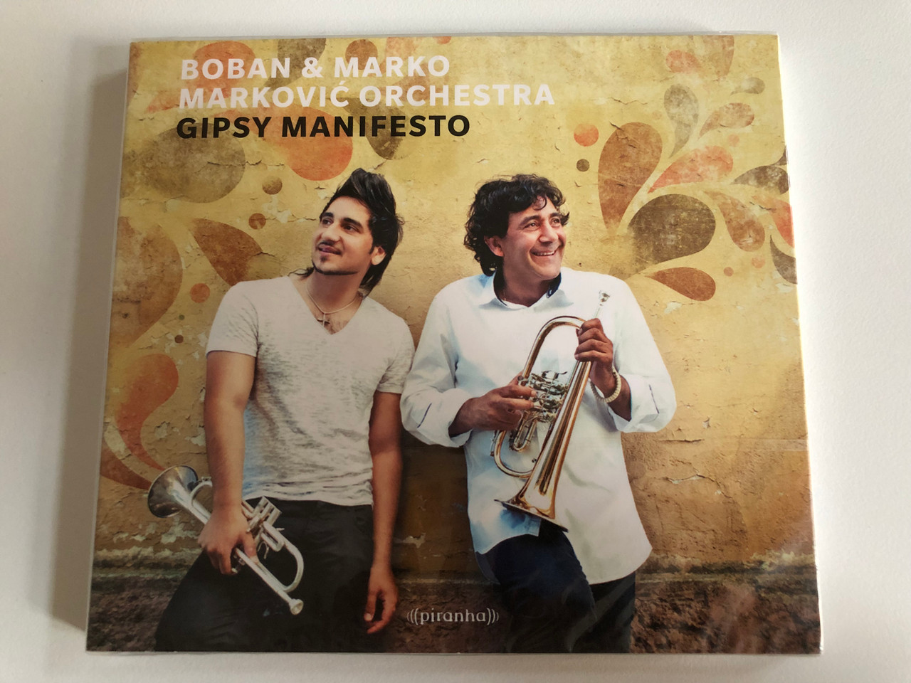 https://cdn10.bigcommerce.com/s-62bdpkt7pb/products/0/images/191604/Boban_Marko_Markovi_Orchestra_Gipsy_Manifesto_Piranha_Audio_CD_2013_CD-PIR2753_1__49114.1631795925.1280.1280.JPG?c=2&_gl=1*12wdbdg*_ga*MjA2NTIxMjE2MC4xNTkwNTEyNTMy*_ga_WS2VZYPC6G*MTYzMTc5MjEyNy44My4xLjE2MzE3OTU3NzUuNDE.