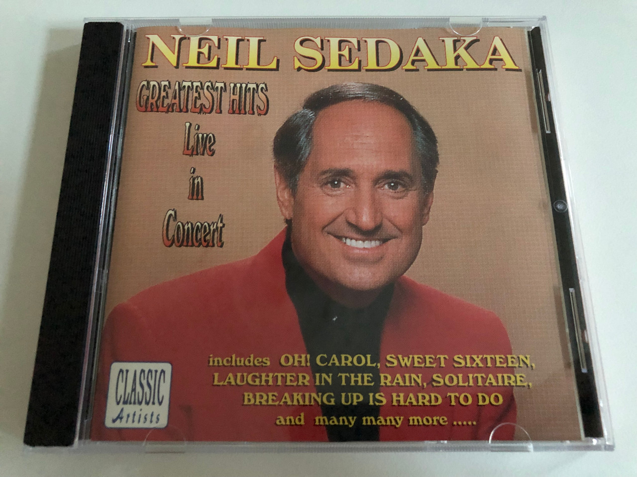 https://cdn10.bigcommerce.com/s-62bdpkt7pb/products/0/images/192678/Neil_Sedaka_Greatest_Hits_Live_In_Concert_Includes_Oh_Carol_Sweet_Sixteen_Laughter_In_The_Rain_Solitaire_Breaking_Up_Is_Hard_To_Do_and_many_many_more..._Tring_Audio_CD_JHD015_1__90132.1632394699.1280.1280.JPG?c=2&_gl=1*8emibu*_ga*MjA2NTIxMjE2MC4xNTkwNTEyNTMy*_ga_WS2VZYPC6G*MTYzMjM3OTQ5Ni45Ni4xLjE2MzIzOTQ1MzYuNDI.
