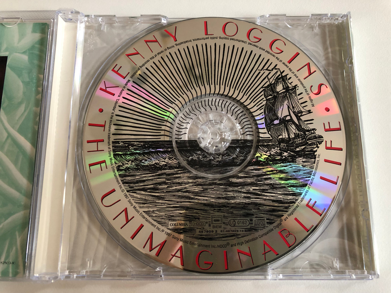 https://cdn10.bigcommerce.com/s-62bdpkt7pb/products/0/images/192937/Kenny_Loggins_-_The_Unimaginable_Life_Columbia_Audio_CD_1997_487809_2_3__10871.1632734890.1280.1280.JPG?c=2&_gl=1*rafi5n*_ga*MjA2NTIxMjE2MC4xNTkwNTEyNTMy*_ga_WS2VZYPC6G*MTYzMjczMzIxOC45OS4xLjE2MzI3MzQ2NjkuNTg.