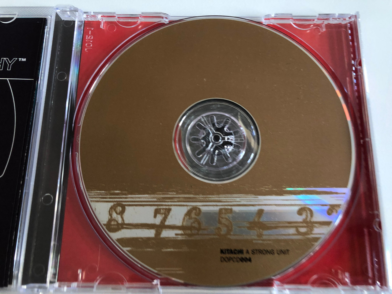 https://cdn10.bigcommerce.com/s-62bdpkt7pb/products/0/images/192987/Kitachi_A_Strong_Unit_Dope_On_Plastic_Audio_CD_1996_DOPCD004_3__29731.1632740196.1280.1280.JPG?c=2&_gl=1*1406msr*_ga*MjA2NTIxMjE2MC4xNTkwNTEyNTMy*_ga_WS2VZYPC6G*MTYzMjczMzIxOC45OS4xLjE2MzI3Mzk3MTAuNDQ.