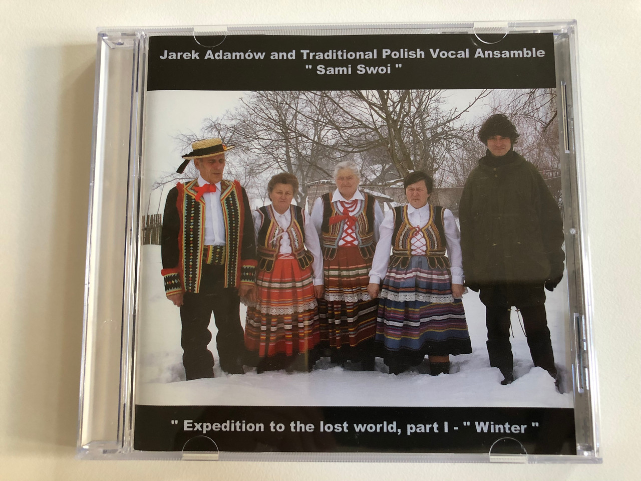 https://cdn10.bigcommerce.com/s-62bdpkt7pb/products/0/images/193095/Jarek_Adamow_and_Traditional_Polish_Vocal_Ansamble_Sami_Swoi_Expedition_to_the_lost_world_part_I_-_Winter_Folken_Music_Audio_CD_2006_CD_01_1__54968.1632816052.1280.1280.JPG?c=2&_gl=1*1vckgz7*_ga*MjA2NTIxMjE2MC4xNTkwNTEyNTMy*_ga_WS2VZYPC6G*MTYzMjgxMzEwMC4xMDEuMS4xNjMyODE1NTQxLjE2
