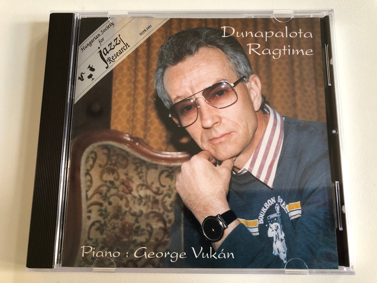 https://cdn10.bigcommerce.com/s-62bdpkt7pb/products/0/images/193105/Dunapalota_Ragtime_-_piano_Gyrgy_Vukn_Hungarian_Society_For_Jazz_Research_Audio_CD_1993_HSJR_2001_1__80708.1632817546.1280.1280.JPG?c=2&_gl=1*14erfa0*_ga*MjA2NTIxMjE2MC4xNTkwNTEyNTMy*_ga_WS2VZYPC6G*MTYzMjgxNzM2My4xMDIuMS4xNjMyODE3Mzk1LjI4